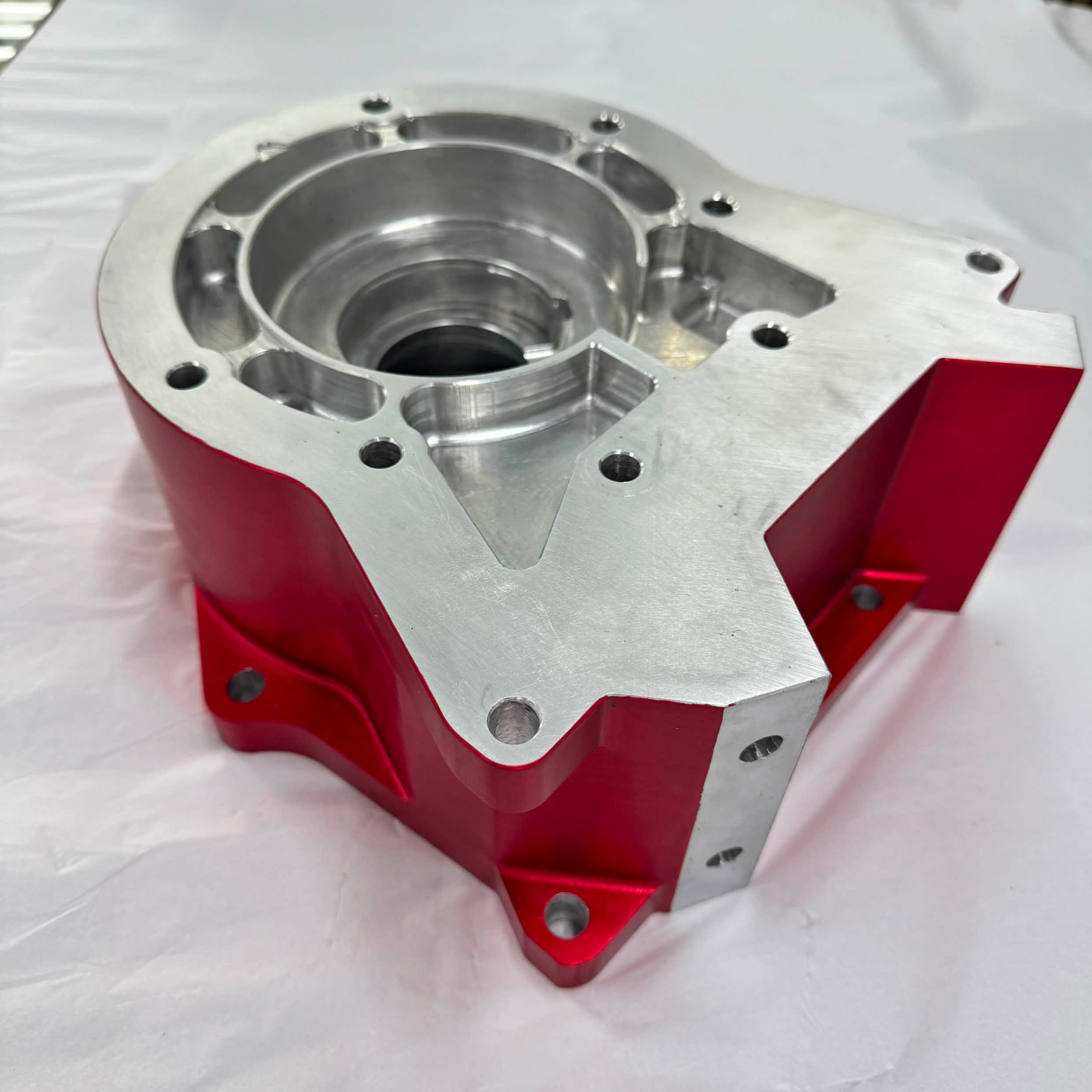 Precision-machined red anodised aluminium housing
