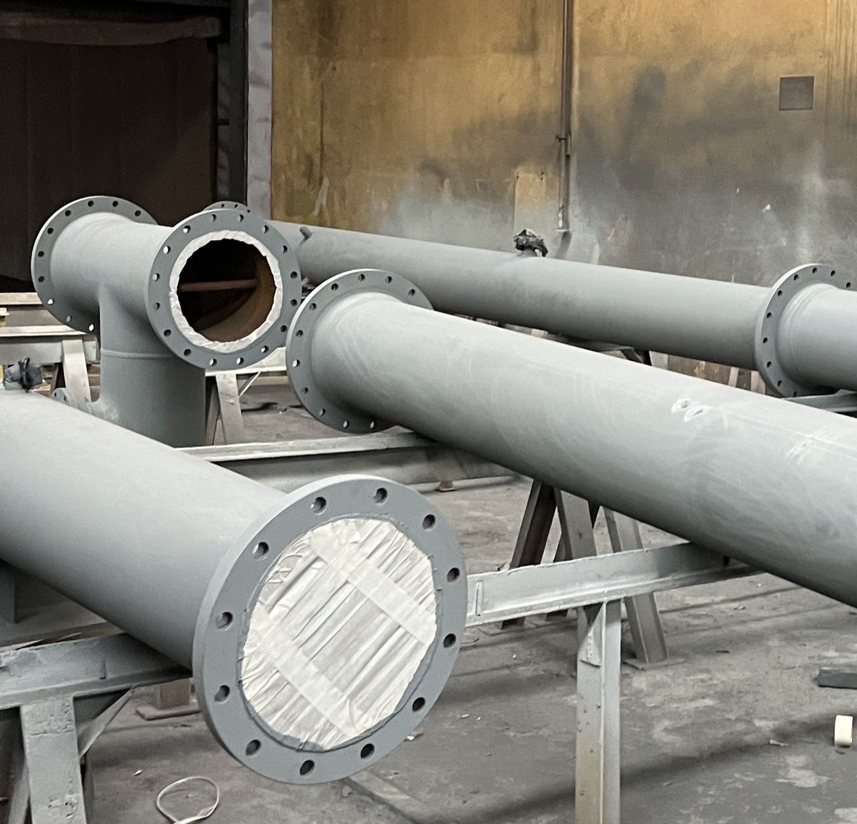Fabricated and flanged pipe spools on trestles in the workshop