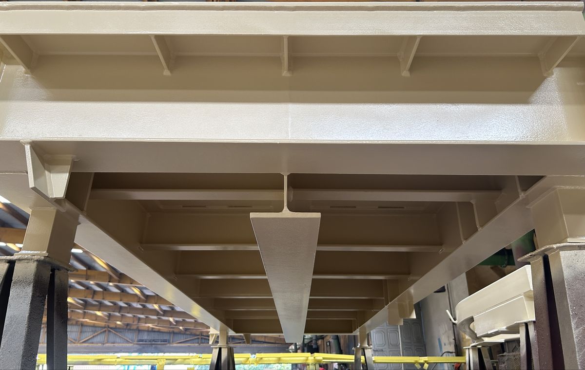 Underside of a heavy fabricated steel platform with gusseted supports